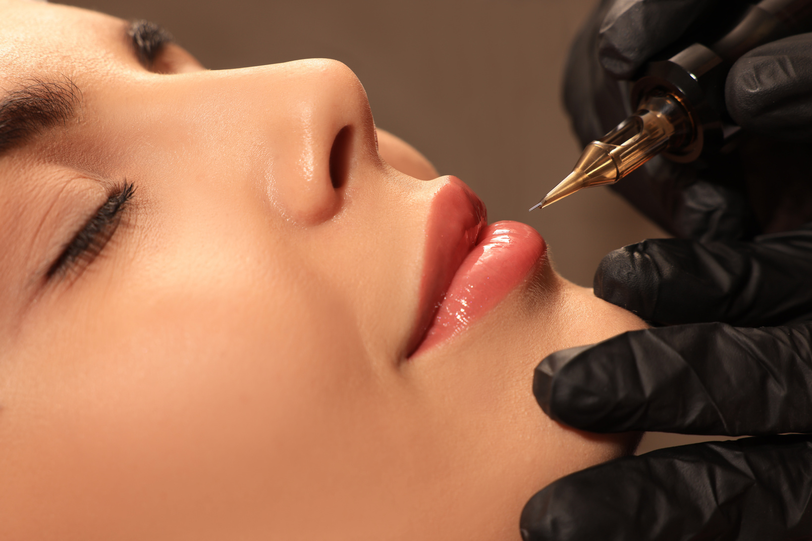 Young Woman Undergoing Procedure of Permanent Lip Makeup in Tattoo Salon, Closeup